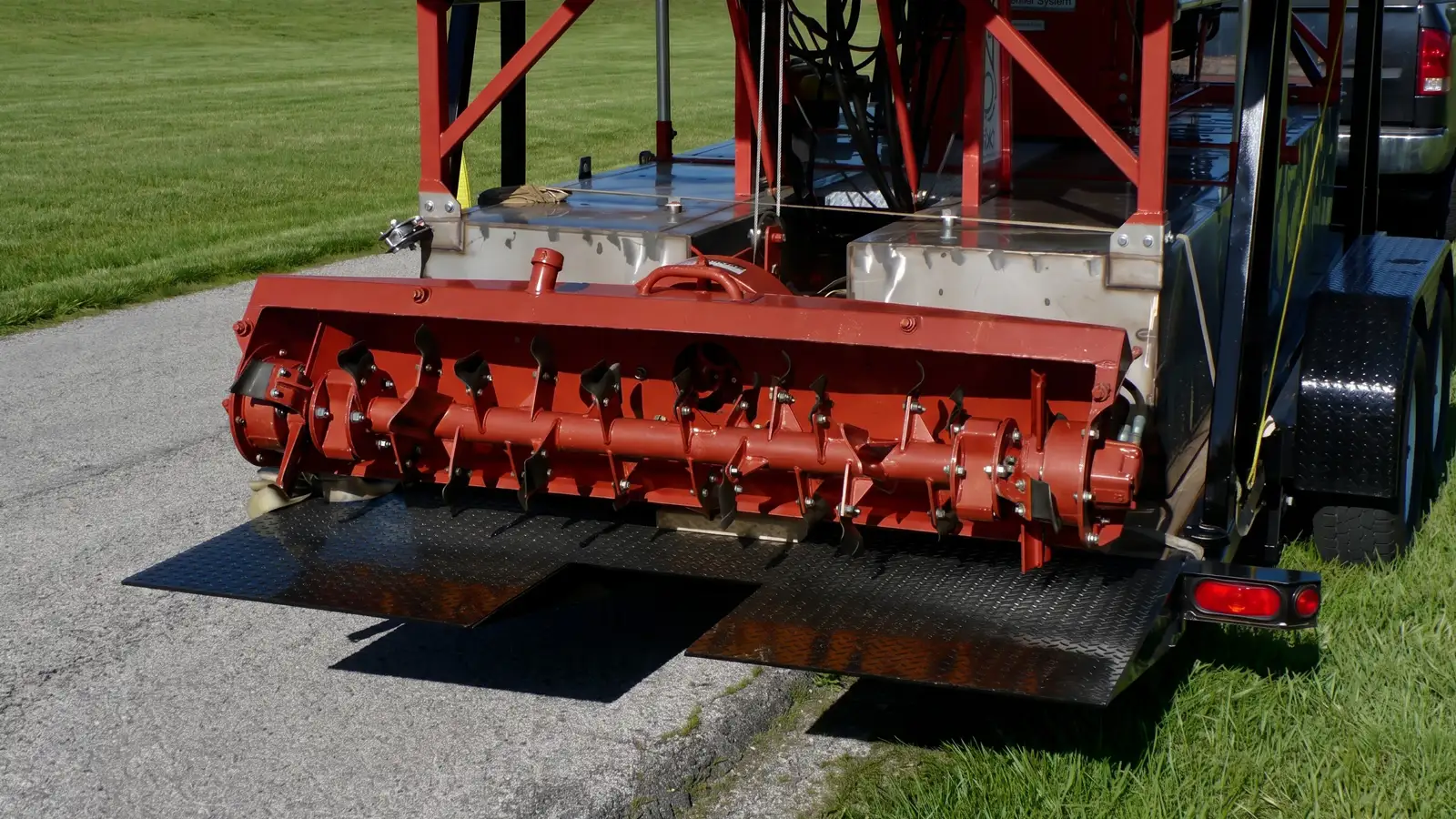 Extra-Wide 66-Inch Cutter Head Rear view of the Sediment Slayer's wide cutter head mounted on the dredge on a trailer