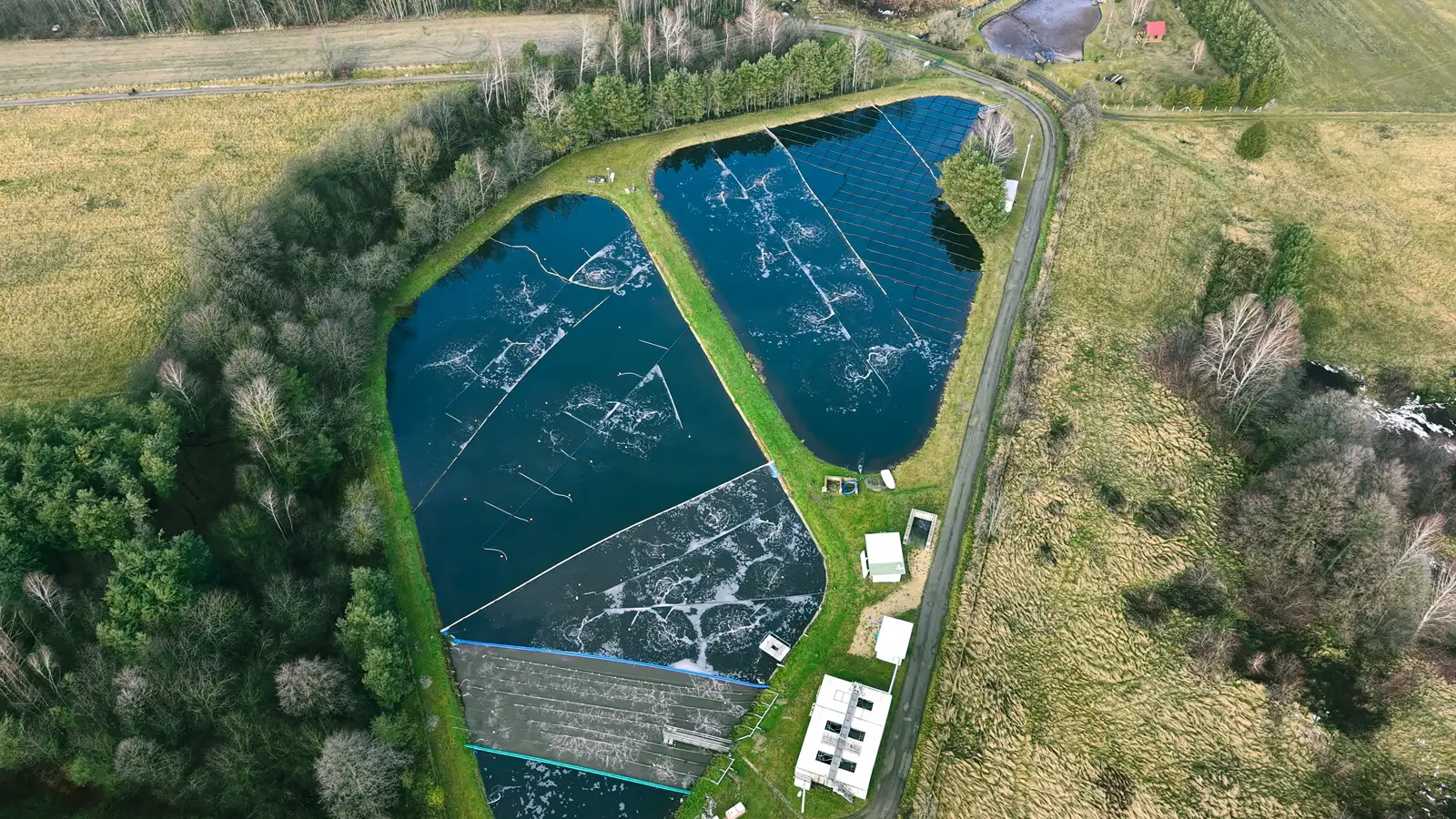 Lagoons and Lakes Aerial view of lined treatment lagoons surrounded by trees and fields