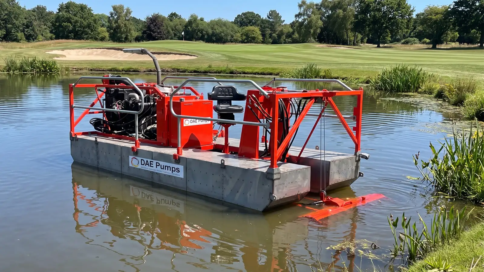 Sediment Slayer Dredge on a Pond DAE Pumps Sediment Slayer pond dredge floating in a reed-lined pond