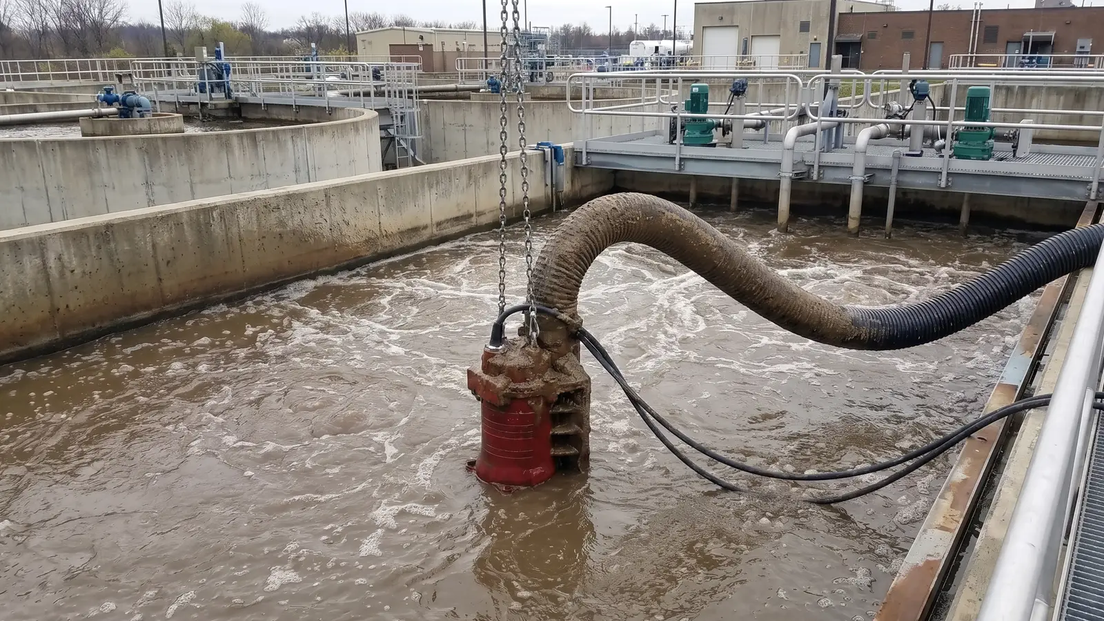 Wastewater and Sludge Pumping Submersible slurry pump moving sludge in a concrete wastewater treatment basin